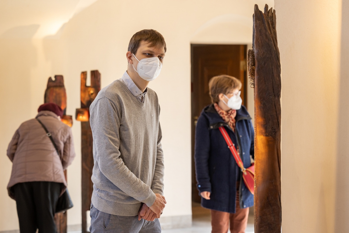 Gäste betrachten Skulpturen aus Holz